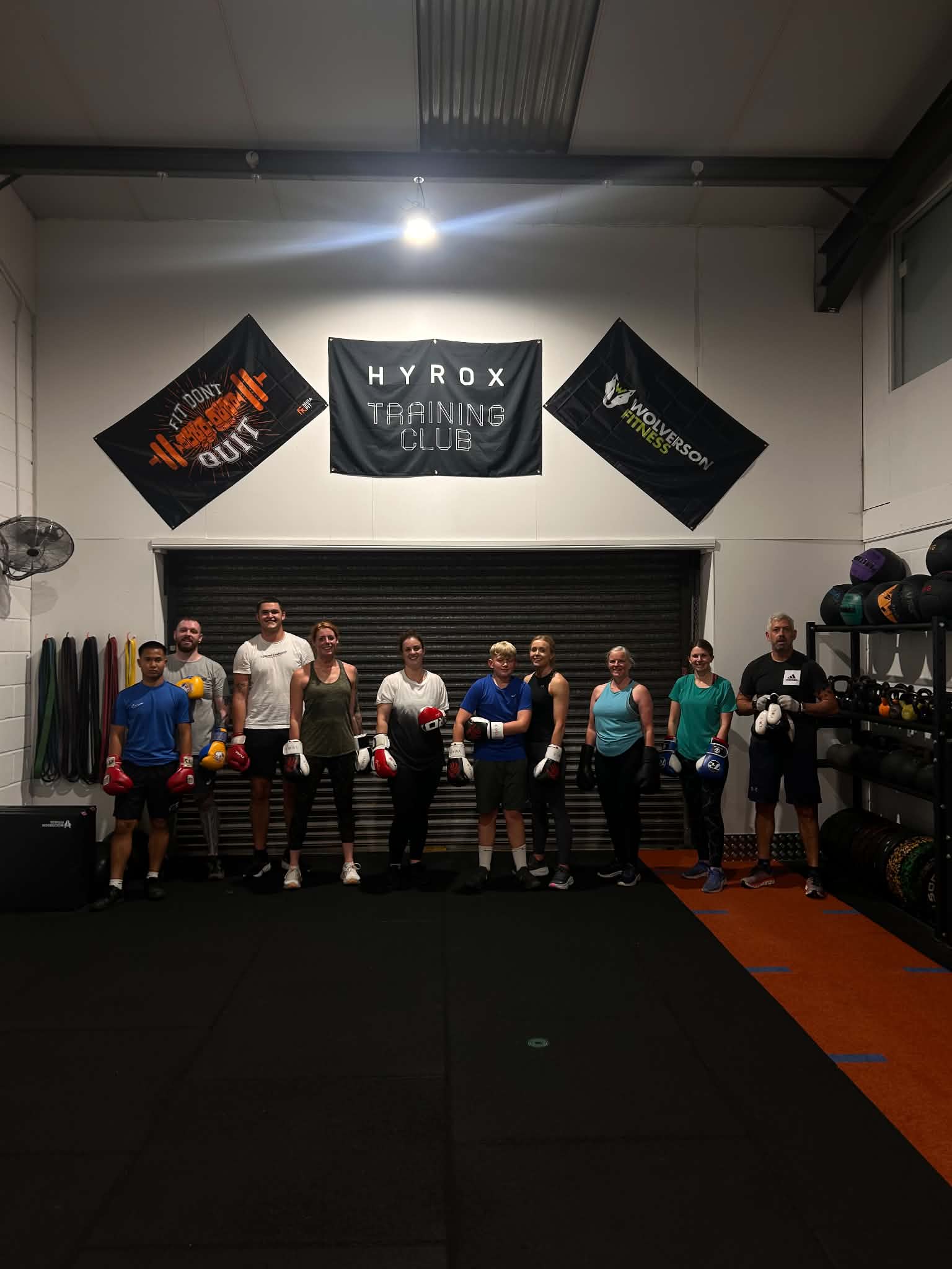 Group training photo in front of the HYROX Training Club wall